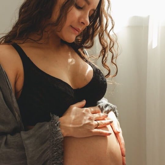 Pregnant woman touching bump