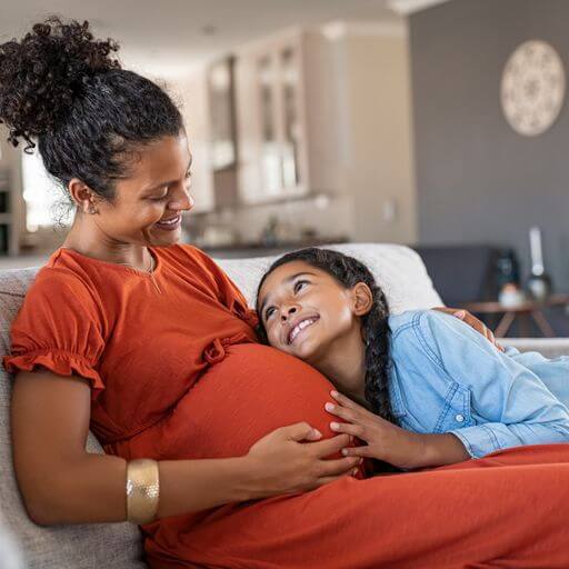 A pregnant woman and her older daughter